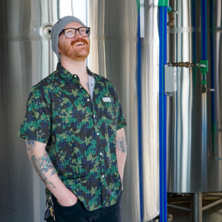 Male wearing camo pattern logo party shirt.